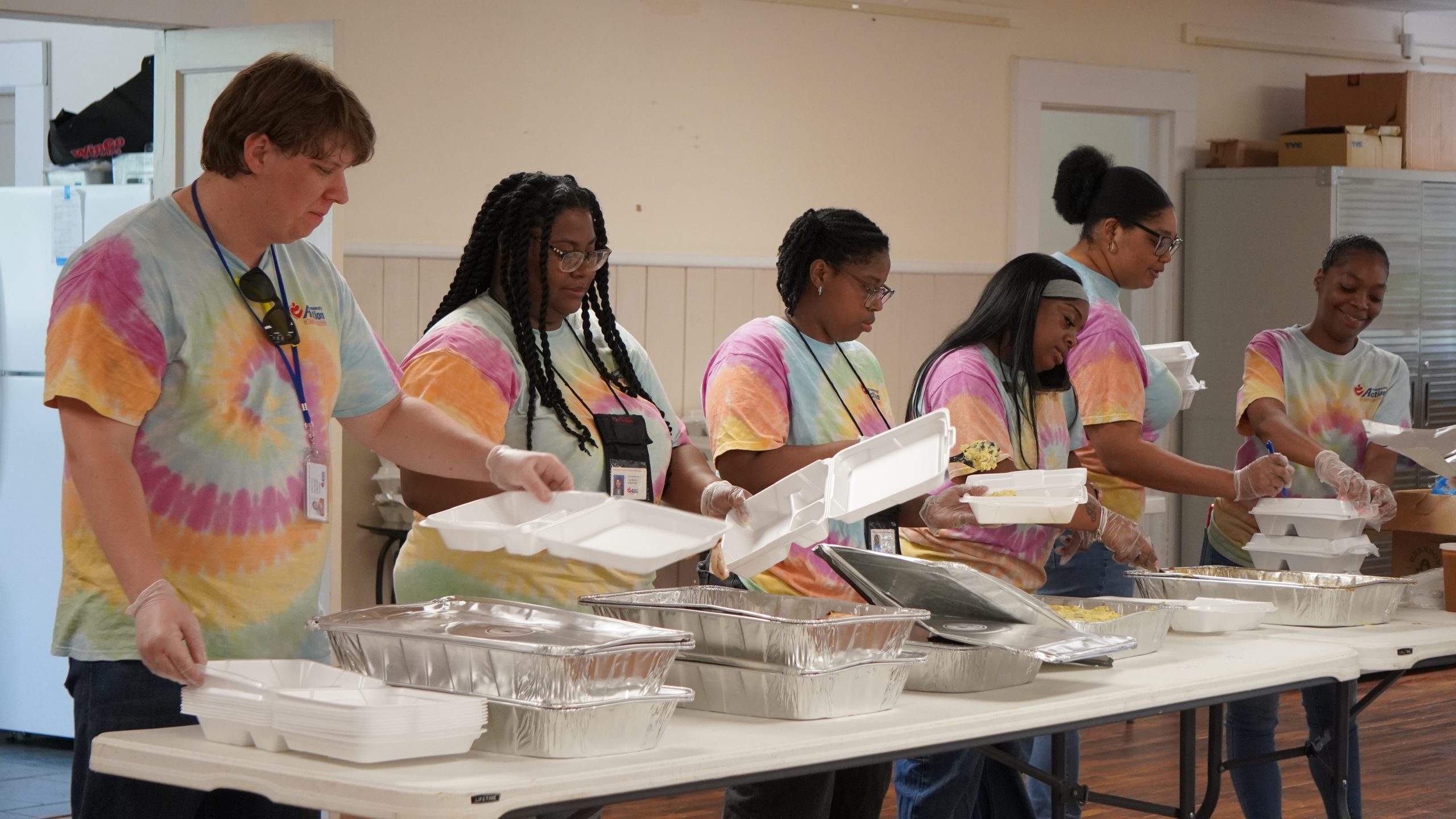 CASOMS staff and volunteers serving hot meals to community members